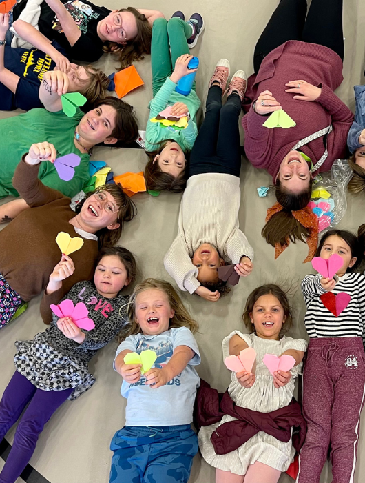 Montessori School of Denver students and staff are engaged in the community, such as making origami hearts for beehives